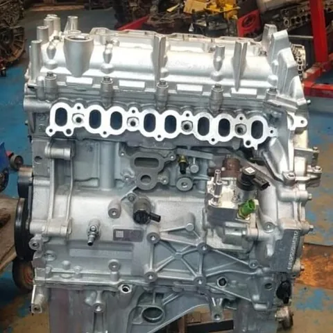 Clean rebuilt four-cylinder engine block and cylinder head on a workshop stand